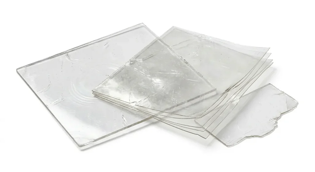 Transparent natural sheet mica plates and fabricated mica films showing perfect clarity