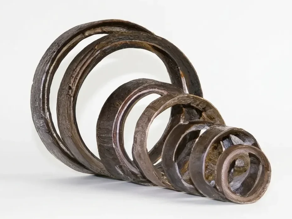 A series of nested, circular industrial mica rings of decreasing sizes arranged in a telescopic formation